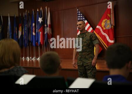 Sgt. Maj. Michael A. Miller, incoming sergeant major of 4th Marine Division, talks to guests at the relief and appointment ceremony at Marine Corps Support Facility New Orleans, March 16, 2017. Miller, who previously served as sergeant major for Combat Logistics Regiment 3 in Okinawa, Japan, said he plans to make sure Marines get the right training to prepare for the rigor of combat. Stock Photo