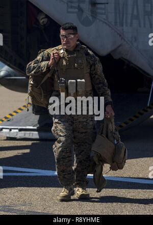 U.S. Marine Corps Staff Sgt. Juan Fuentes, rifleman, with security platoon, 3rd Battalion, 5th Marine Regiment exits a CH-53E Super Stallion on Camp Pendleton, Calif. March 16, 2017. Marines with 3rd Battalion, 5th Marine Regiment, are training for an upcoming deployment with the 15th Marine Expeditionary Force. Stock Photo