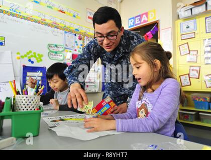 YOKOSUKA, Japan (March 16, 2017) Seaman Jonathon Nava, assigned to the U.S. 7th Fleet flagship USS Blue Ridge (LCC 19), pasrticipates in a math exercise during a community relations event at Sullivan's Elementary School. Blue Ridge is in an extensive maintenance period in order to modernize the ship to continue to serve as a robust communications platform in the U.S. 7th Fleet area of operations. Stock Photo