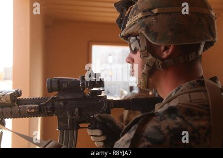 MARINE CORPS AIR-GROUND TASK FORCE TRAINING CENTER TWENTYNINE PALMS, Calif. – Lance Cpl. Devin Sundholm, a rifleman with Battalion Landing Team 1st Battalion, 5th Marines, 15th Marine Expeditionary Unit, provides security after clearing a building during Realistic Urban Training, March 16, 2017. RUT trains Marines and Sailors to operate in an urban environment for the upcoming deployment later this year. The MEU maintains a high level of readiness to be where needed, when needed. Stock Photo