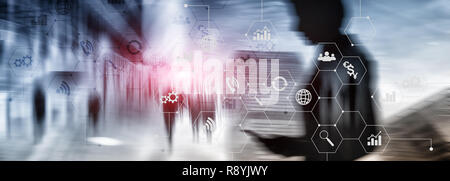 Double exposure mixed media. Diagrams and icons on hologram screen. Business people and modern city on background. Stock Photo
