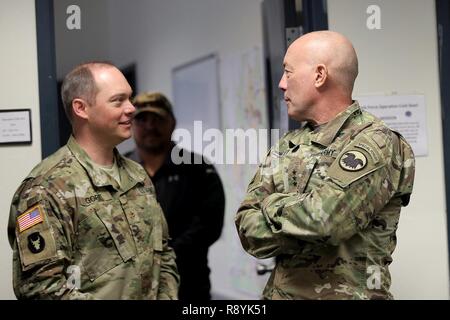 Maj. Ryan Gore, left, 86th Training Division and Operation Coldsteel Operations Officer, meets briefly with LTG Charles Luckey, Commanding General, U.S. Army Reserve, during Operation Cold Steel at Fort McCoy, Wisconsin, Mar. 18, 2017. Operation Cold Steel is the U.S. Army Reserve’s crew-served weapons qualification and validation exercise to ensure that America’s Army Reserve units and Soldiers are trained and ready to deploy on short-notice and bring combat-ready and lethal firepower in support of the Army and joint partners anywhere in the world. This was Luckey’s second visit in reviewing  Stock Photo