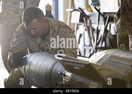 U.S. Marine Corps Staff Sgt. Jeffrey W. Stiles, an aviation ordnance system technician with Marine Aviation Logistics Squadron 13 (MALS-13) gives a period of instruction on the Guided Bomb Unit 12 (GBU-12) during the first ever Aircraft Maintenance Officer Course (AAMOC) at Marine Corps Air Station Yuma, Ariz., March 17, 2017. AAMOC will empower Aircraft Maintenance Officers with leadership tools, greater technical knowledge, and standardized practices through rigorous academics and hands on training in order to decrease ground related mishaps and increase sortie generation. Stock Photo