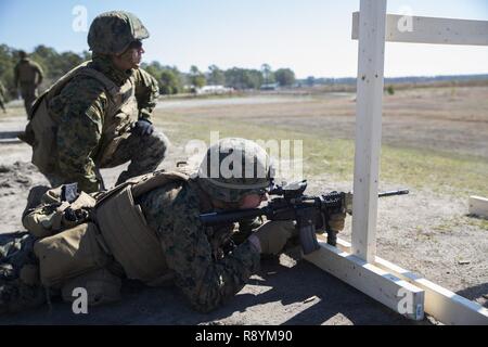 Sgt. Ethan J. Wright, a rifleman Marine with Special Purpose Marine Air-Ground Task Force - Southern Command, participates in a Table 3 unknown distance range during pre-deployment training at Range K-501 aboard Marine Corps Base Camp Lejeune, North Carolina, March 16, 2017. The training was conducted to enhance the Ground Combat Element’s readiness for future security cooperation operations in Central America. Stock Photo