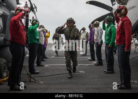 WATERS EAST OF THE KOREAN PENINSULA (March 20, 2017) Side boys from the aircraft carrier USS Carl Vinson (CVN 70) render honors to Adm. Um, Hyun Seong, the Republic of Korea chief of naval operations, on the flight deck. The Carl Vinson Carrier Strike Group is on a regularly scheduled Western Pacific deployment as part of the U.S. Pacific Fleet-led initiative to extend the command and control functions of U.S. 3rd Fleet. U.S Navy aircraft carrier strike groups have patrolled the Indo-Asia-Pacific regularly and routinely for more than 70 years. Stock Photo