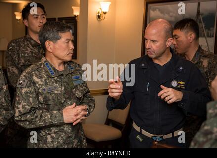 WATERS EAST OF THE KOREAN PENINSULA (March 20, 2017) Rear Adm. Jim Kilby, commander, Carrier Strike Group 1, right, speaks to Gen. Jeong, Kyeongdoo, chief of staff of the Republic of Korea Air Force, left, in the commanding officer’s in-port cabin aboard the aircraft carrier USS Carl Vinson (CVN 70). The Carl Vinson Carrier Strike Group is on a regularly scheduled Western Pacific deployment as part of the U.S. Pacific Fleet-led initiative to extend the command and control functions of U.S. 3rd Fleet. U.S Navy aircraft carrier strike groups have patrolled the Indo-Asia-Pacific regularly and rou Stock Photo