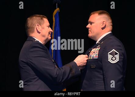 U.S. Air Force General Robin Rand, commander of Air Force Global Strike Command pins the Silver Star on retired Master Sgt. Kristopher Parker, an explosive ordnance disposal technician March 17, 2017, at Dyess Air Force Base, Texas for Parker’s courageous actions while deployed to Afghanistan in May of 2014. Parker distinguished himself by bravery and devotion to duty in connection with military operations against an armed enemy of the United States as an EOD team leader. Stock Photo