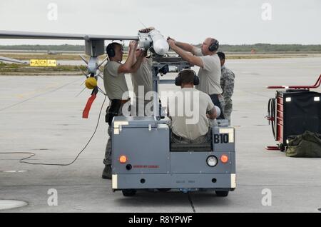 114th Aircraft Maintenance weapon loaders mount a training missile on a F-16C during a training mission March 14, 2017, Naval Air Station Key West, FL. The purpose of the deployment was to train with the U.S. Navy and Canadian Air Force. This training serves as the culmination of the 175th Fighter Squadron air-to-air training. Stock Photo