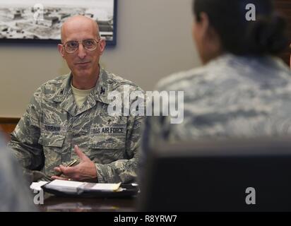 U.S. Air Force Col. David Terrinoni, Joint Base Langley-Eustis senior chaplain, speaks with fellow Integrated Delivery System members regarding action plans they will deliver to senior leaders at Joint Base Langley-Eustis, Va., March 9, 2017. The actions plans are discussed during the quarterly Community Action Information Board, where commanders meet to put the proposed improvements into action. Stock Photo
