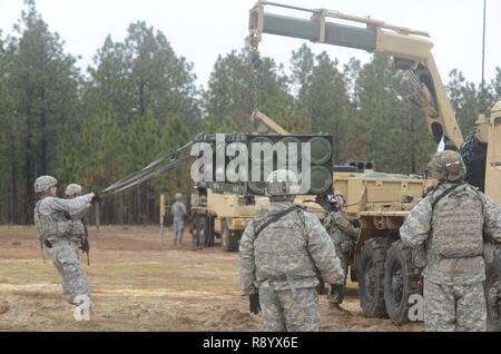 FORT BRAGG, N.C. - Soldiers from the 18th Field Artillery Brigade unload ammunition pods for High Mobility Artillery Rocket Systems on March 14. HIMARS crews from Alpha and Bravo Battery, 3rd Battalion, 27th Field Artillery Regiment changed out their ammunition pods following a live-fire exercise earlier that morning. Stock Photo