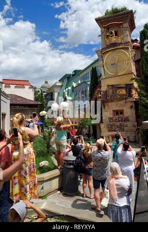 Georgia, Tbilisi, Old City, tourists in front of the Clock tower attached to the Puppet theatre dedicated to Rezo Gabriadze Stock Photo