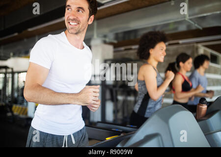 Happy gorup of healthy people training in gym Stock Photo