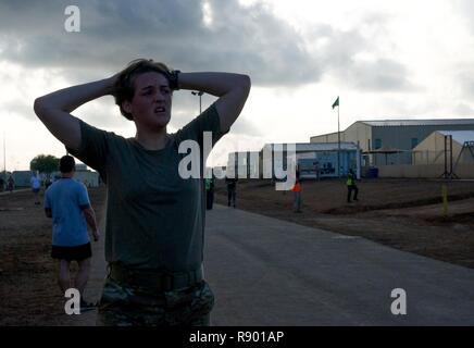 U.S. Army 1st Lt. Elizabeth Kelly, an intelligence officer assigned to Headquarters and Headquarters Company, 1st Battalion, 153rd Infantry Regiment, takes a brake after completing the 5 mile run at Camp Lemonnier, Djibouti, March 19, 2017. Stock Photo
