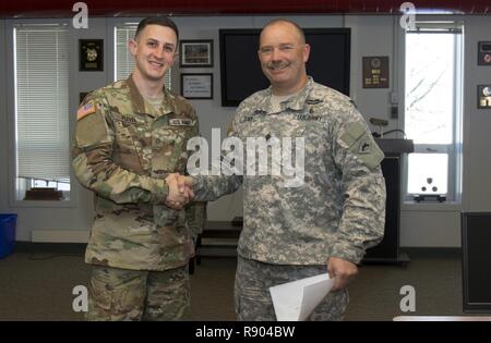 U.S. Army Command Sgt. Maj. Joseph T. Quick, state command sergeant major, Vermont National Guard, congratulates U.S. Pfc. Philip Plevel, Bravo Battery, 1st Battalion, 101st Field Artillery Regiment, Vermont National Guard, for being the junior enlisted runner up during the Vermont Best Warrior Competition at Camp Ethan Allen Training Site, Jericho, Vt., March 19, 2017.  Vermont Soldiers competed in a variety of Soldier tasks in order to move onto the regional competition in April. Stock Photo