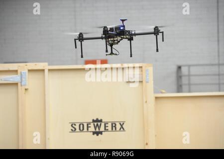 Employees of Planck Aerosystems and WiBotic demonstrate drone autonomous landing and charging technology during the ThunderDrone Rodeo at the newest SOFWERX facility in Tampa, Fla., Nov. 1, 2017. ThunderDrone is a U.S. Special Operations Command initiative dedicated to drone prototyping, which focuses on exploring drone technologies through idea formation, testing, and demonstration. Stock Photo