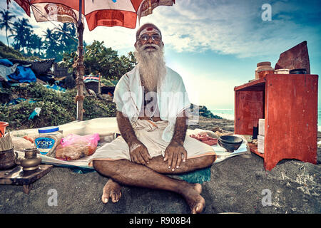Varkala, Kerala, India – November 30, 2017: Portrait of unidentified Indian Brahman on beach in Varkala. Daily lifestyle in rural area in South India. Stock Photo