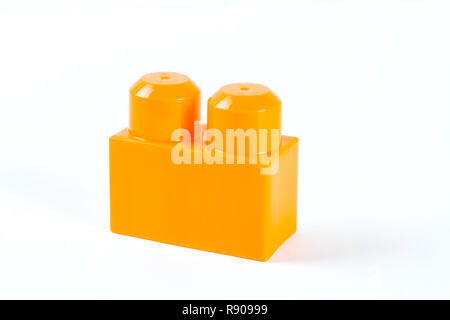 Orange plastic building block isolated on white background Stock Photo
