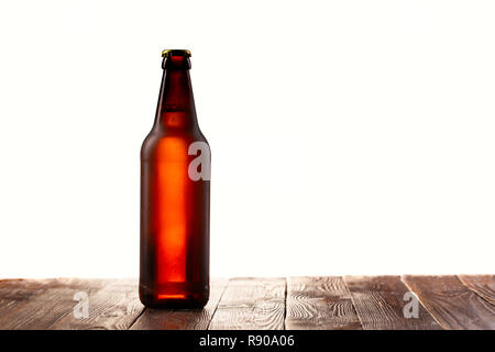 Frosted buttle of light beer on wood table Stock Photo