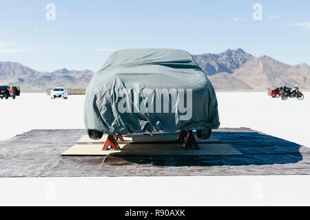 Race car covered with protective cloth in the Salt Flats Stock Photo