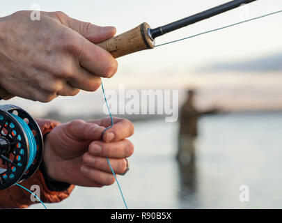 Closeup of a fisherman hand holding a fishing rod Stock Photo - Alamy