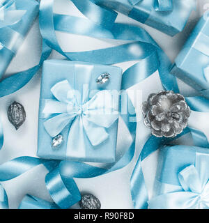 Christmas boxes with gifts blue color on white background cones nuts decor. Top view flat lay square Selective focus. Square Stock Photo