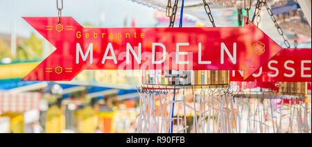 sign on a mobile shop at the cannstatt fun fair in stuttgart, germany advertising roasted almonds Stock Photo