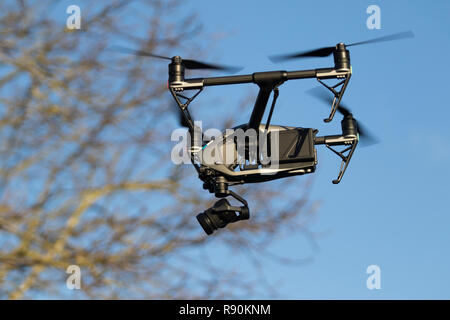 Drone flying in the air against trees and blue sky- DJI Inspire 2 Stock Photo