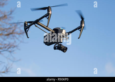 Drone flying in the air against trees and blue sky- DJI Inspire 2 Stock Photo