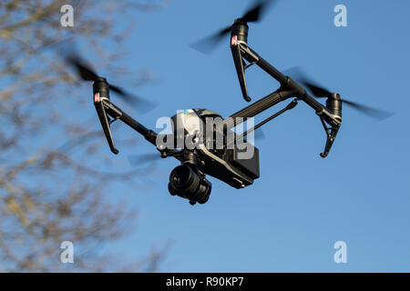 Drone flying in the air against trees and blue sky- DJI Inspire 2 Stock Photo