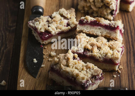 Homemade baked raspberry bars on rustic wooden table close up, selective focus Stock Photo