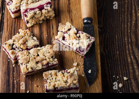 Homemade baked raspberry bars on rustic wooden table close up, selective focus Stock Photo