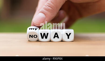 Hand is turning a dice and changes the expression 'no way' to 'my way' Stock Photo