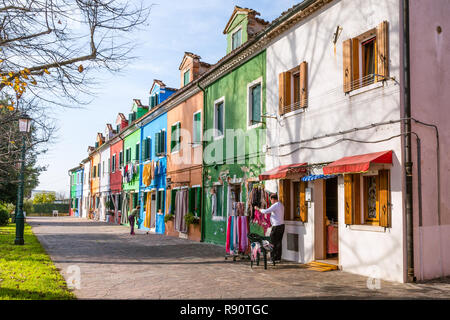 Burano Venice, Italy - October 29, 2016: Shop owener preparing his colorful shop on the island Burano in Venice Italy Stock Photo