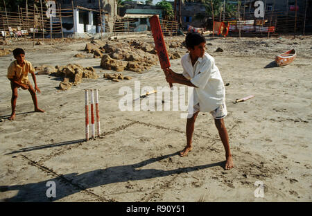 Children playing cricket, India
