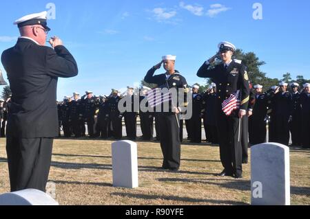 PENSACOLA, Fla. -- Service members salute at the gravesite of a Pearl Harbor survivor during the Pensacola-area Chief Petty Officer's Association (PACPOA)-sponsored Pearl Harbor Remembrance Ceremony Dec. 7 at Barrancas National Cemetery onboard Naval Air Station Pensacola, Fla. The PACPOA coordinated the hour-long ceremony, during which service members placed flags on the gravesites of Pearl Harbor veterans interred at the cemetery. Stock Photo