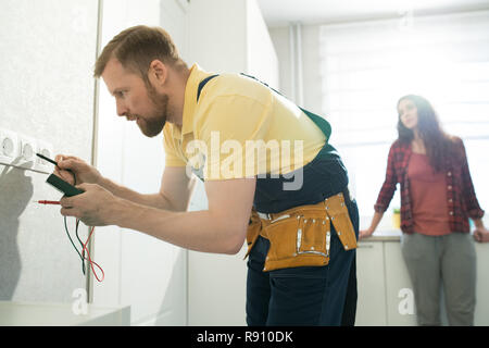 Handyman checking socket in flat Stock Photo