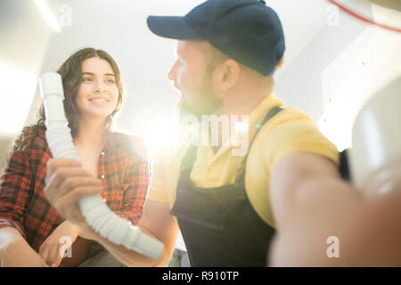 Plumber changing sink pipe Stock Photo