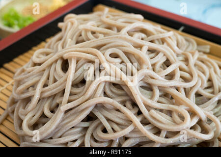 Traditional Japanese meal with cold soba noodles on a sieve bamboo tray close up Stock Photo