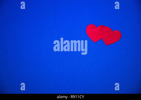 Two red hearts on blue background. St. Valentine's day. Copy space Stock Photo