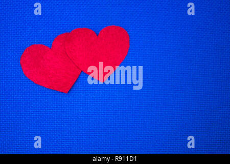 Two red hearts on blue background. St. Valentine's day. Copy space Stock Photo