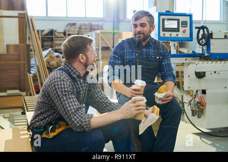 Factory workers having break at workplace Stock Photo