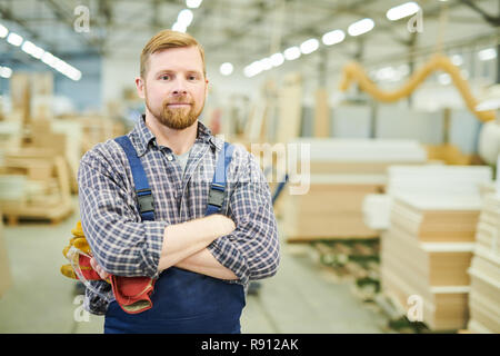 Smiling young worker at furniture factory Stock Photo