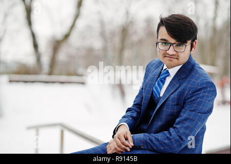 Stylish indian business man in suit and glasses posed at winter day outdoor. Stock Photo