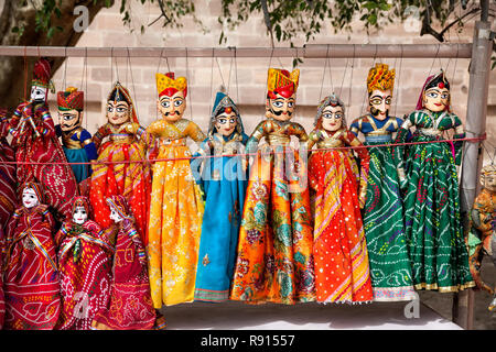 Colorful Rajasthan puppets hanging in the shop of Jodhpur City Palace, India Stock Photo