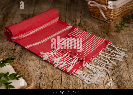 Handwoven hammam Turkish cotton towel on wooden background Stock Photo