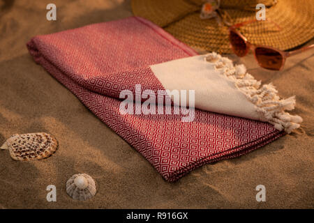 Handwoven hammam Turkish cotton towel on beach Stock Photo