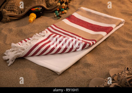 Handwoven hammam Turkish cotton towel on beach Stock Photo