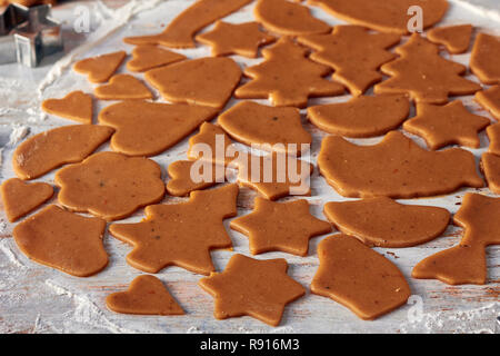 Carved out cookies shapes from gingerbread dough Stock Photo
