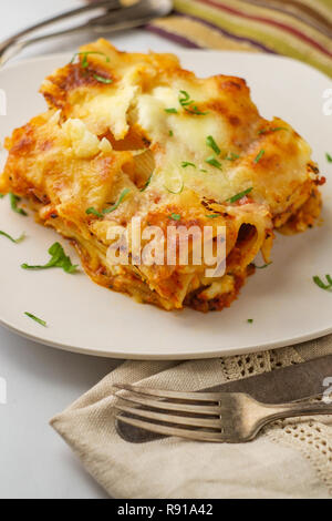 Italian-American cuisine baked ziti lasagna with mozzarella cheese Stock Photo