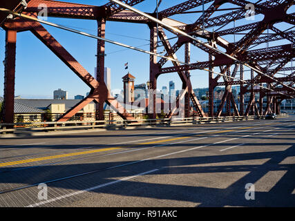 Lifting metal truss transport and pedestrian Broadway bridge across Willamette river in sunny weather cast fancy long shadows of its structure Stock Photo